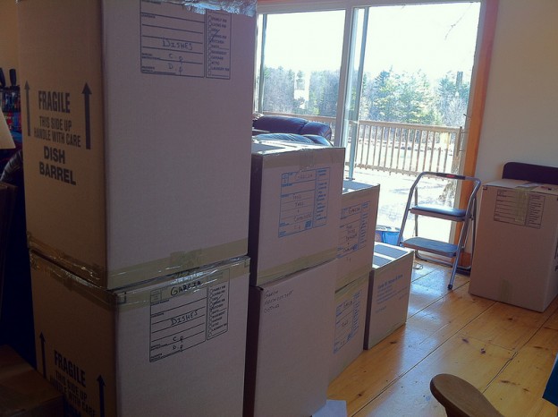 Stack of filled packing boxes in front of glass door