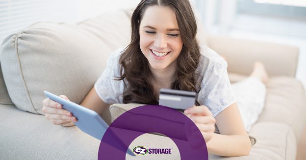 Smiling woman holding tablet and credit card