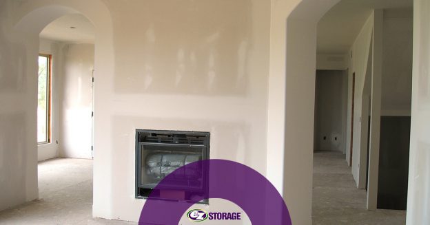 Home undergoing remodeling with EZ Storage logo