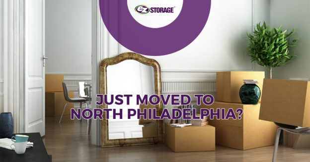 Room filled with moving boxes and a large mirror on against the wall