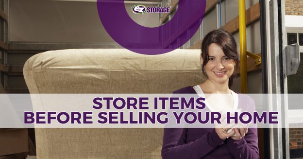 Woman holding a mug standing in front of the back of an open moving truck