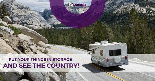 A mobile home driving through a cliffside road with a forest and mountains in the background