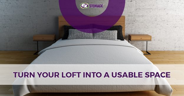 A grey bed on a wooden bedframe in an empty room