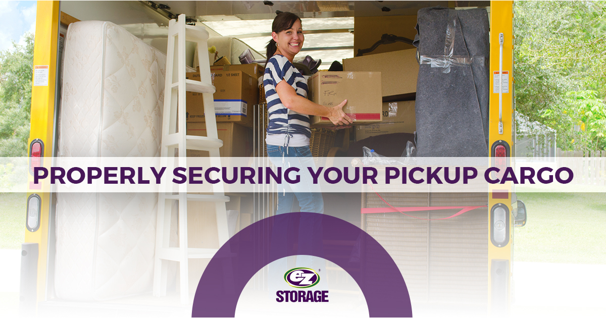 Women smiling holding a box inside a moving truck and text "Properly securing your pickup cargo"