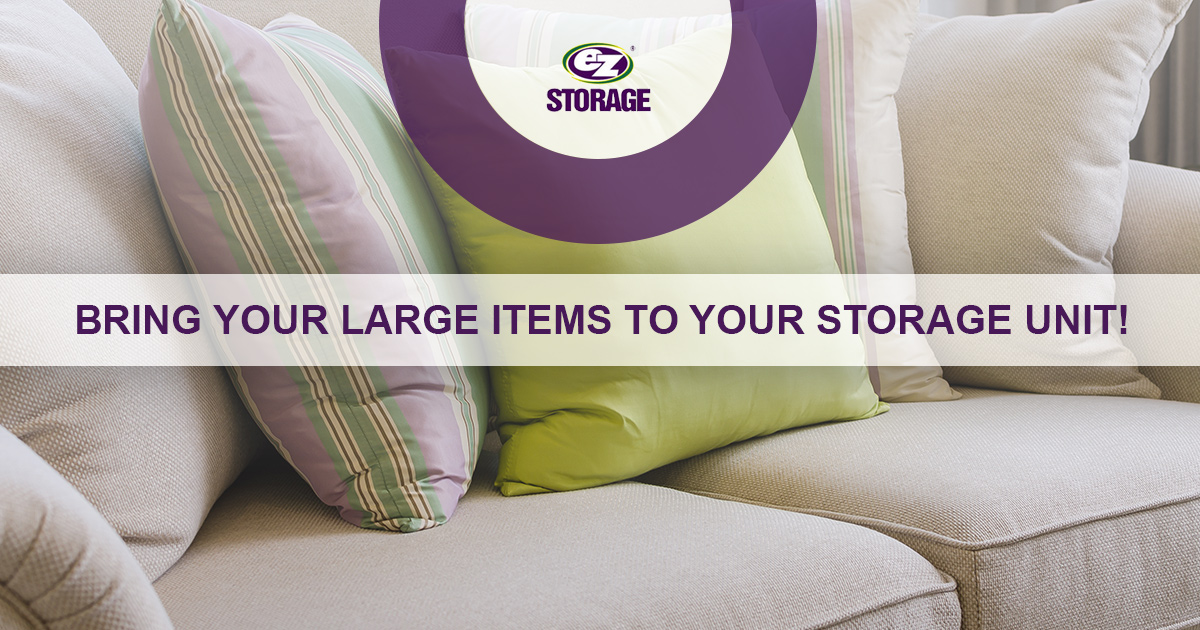 Large couch with several couch pillows with text "bring your large items to your storage unit"