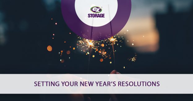 Hands holding up a lit sparkler and text "Setting your New Year's resolutions"