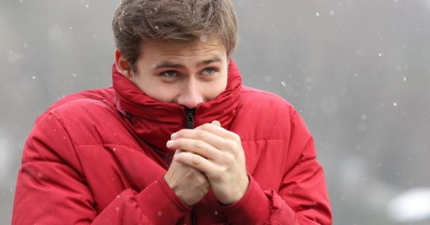 Man wearing red winter parka bundled up for the cold