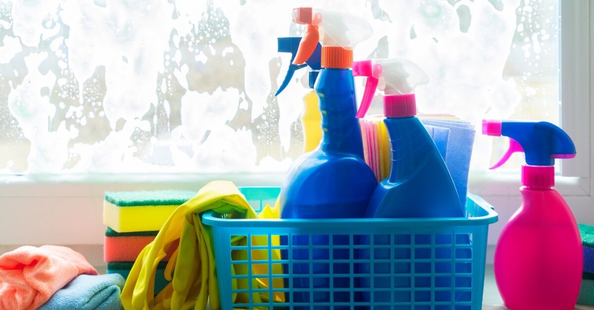 Plastic container full of cleaning supplies