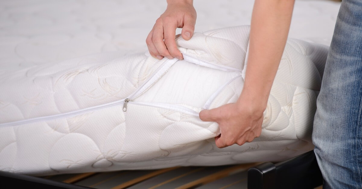 Man opening mattress cover