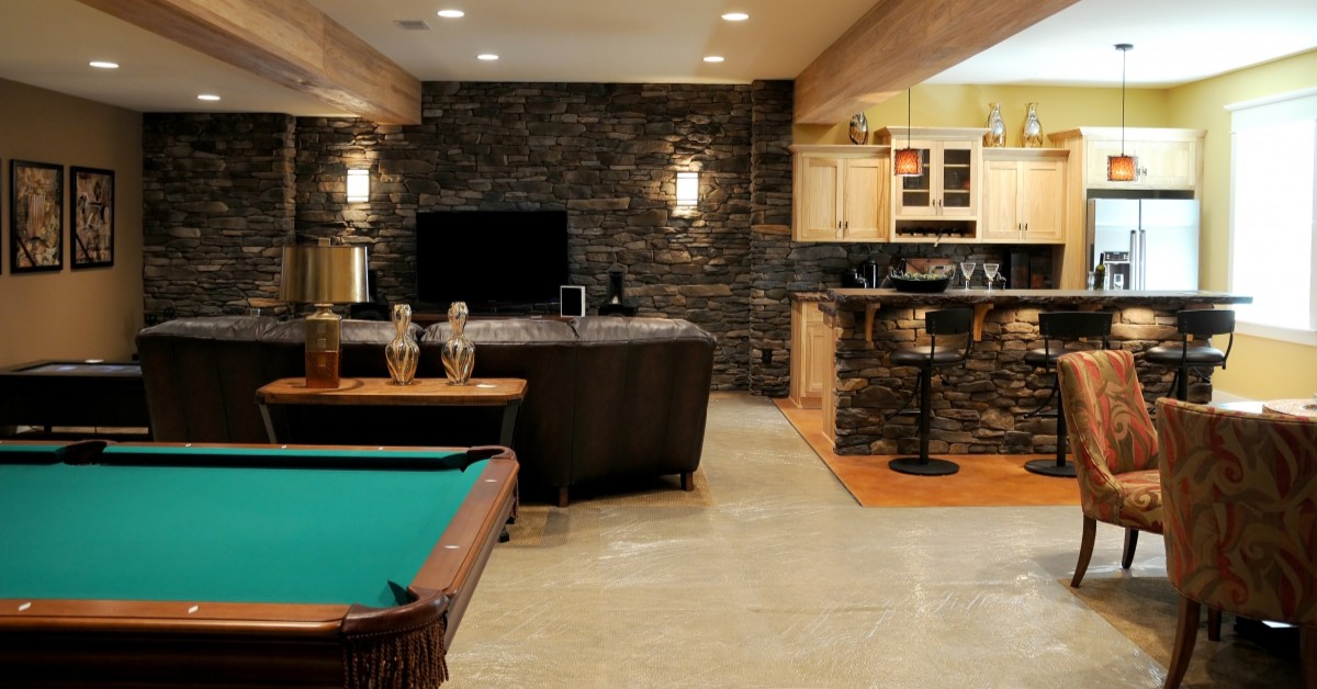 Finished basement with pool table, leather couch, and bar