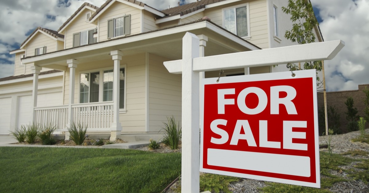 External shot of home with sign that reads "for sale"