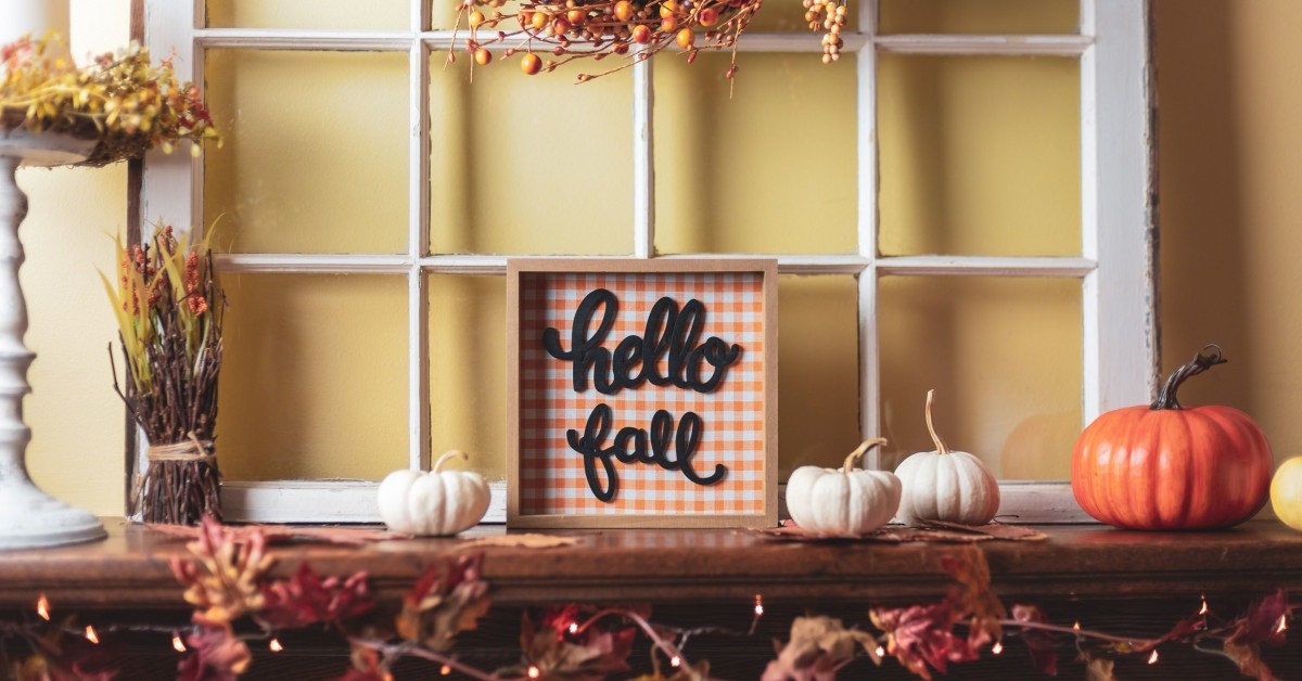 Credenza decorated in fall colors with sign that reads "hello fall"