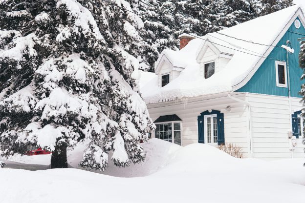 Blue House Covered in Snow