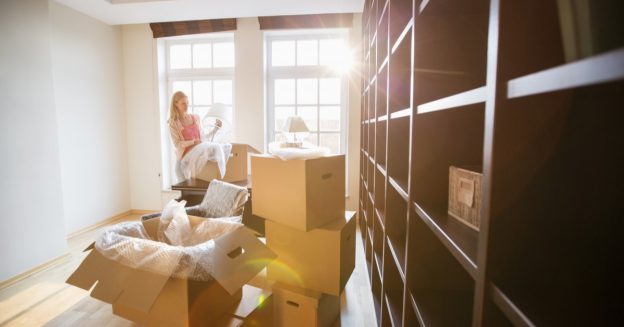 Woman moving and packing a lamp