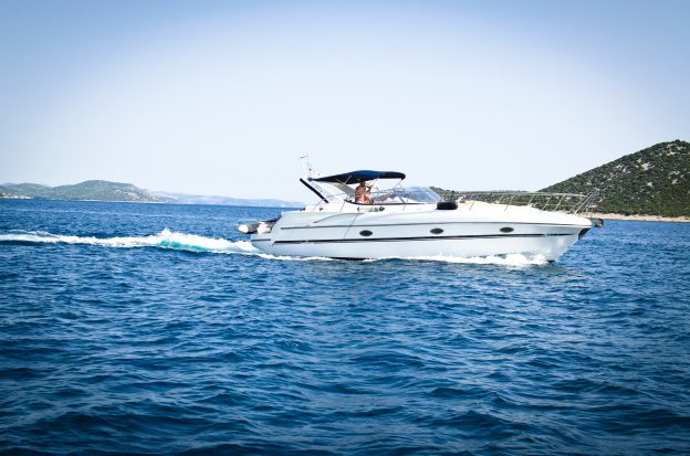 White speedboat on body of water