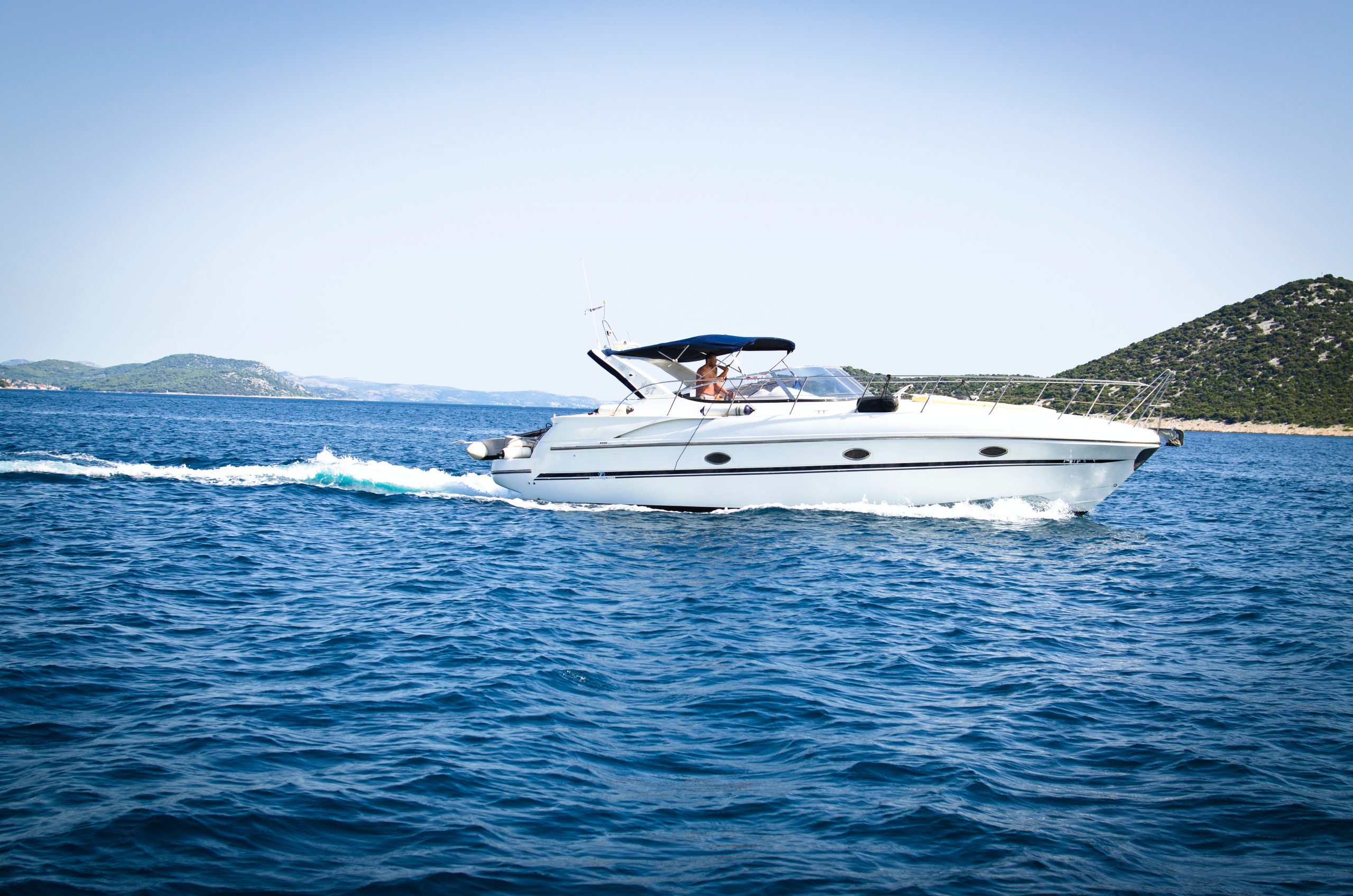 White speedboat on body of water