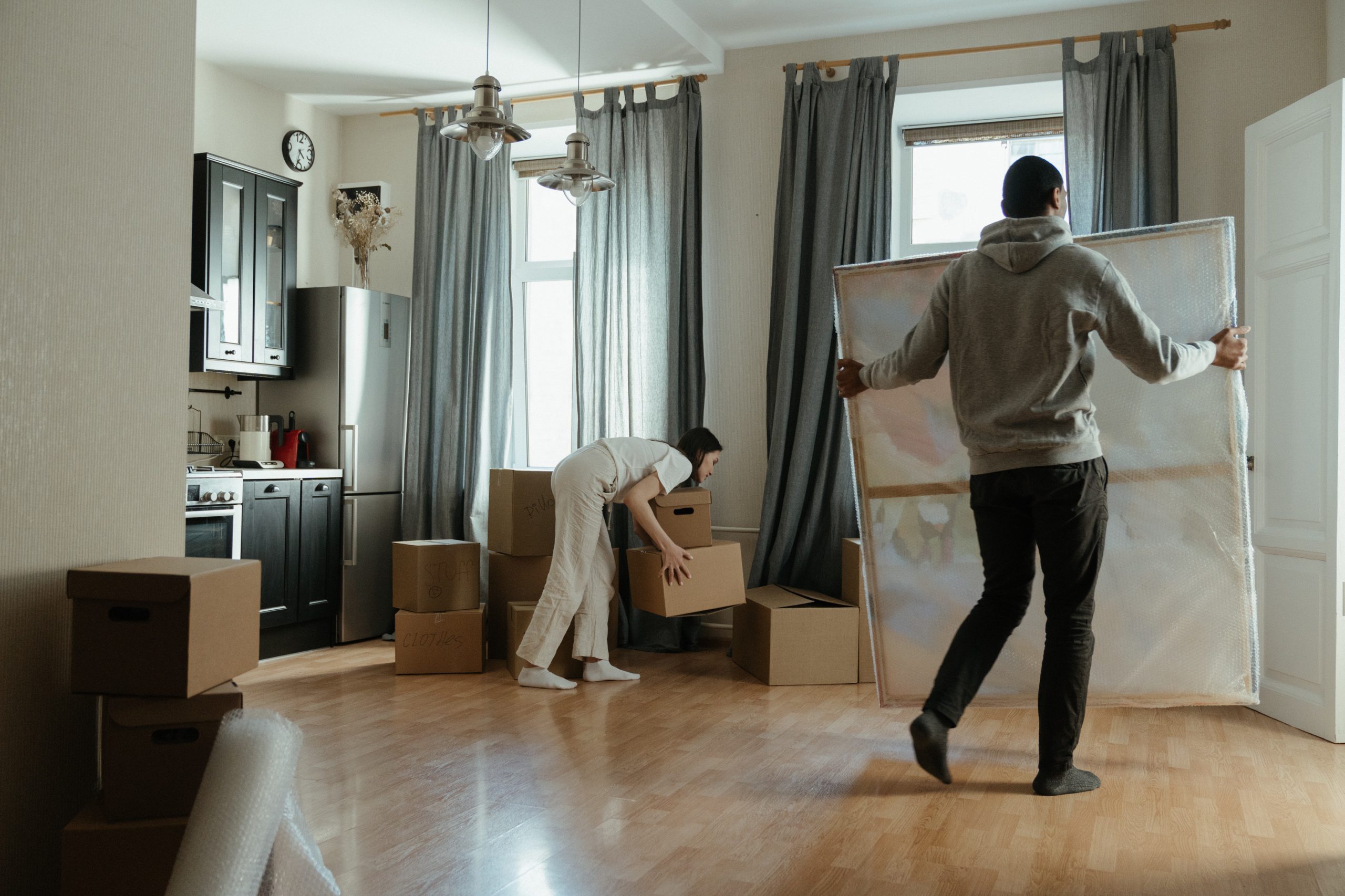 Man and woman moving items out of home